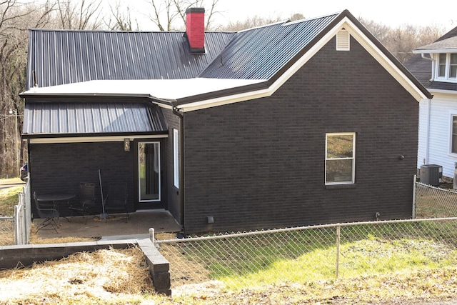 back of house featuring central AC and a patio area