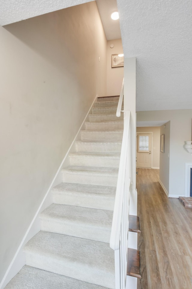 stairs with hardwood / wood-style flooring