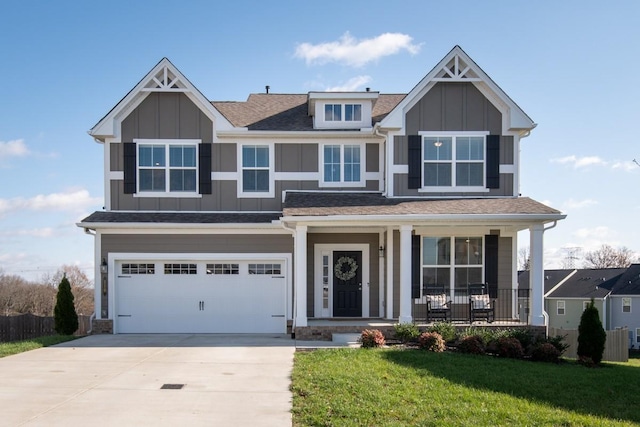 craftsman-style house featuring covered porch, a garage, and a front lawn