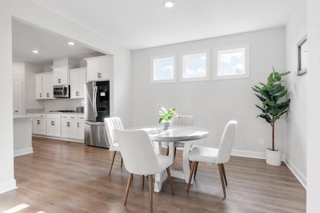 dining room with hardwood / wood-style flooring