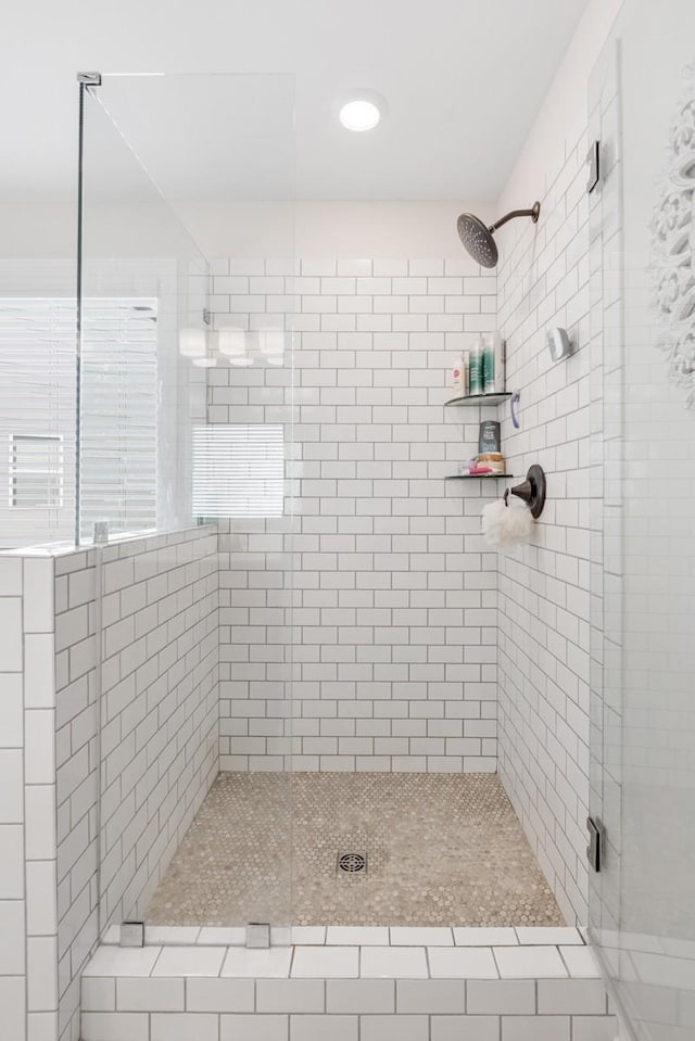 bathroom with a shower with door