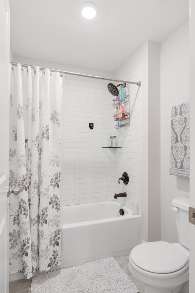 bathroom with tile patterned floors, shower / bath combo, and toilet