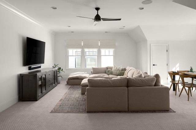 carpeted living room with ceiling fan and crown molding