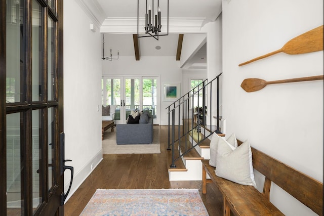 foyer entrance with vaulted ceiling with beams, a notable chandelier, dark wood-type flooring, and french doors