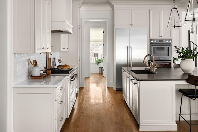 kitchen featuring sink, white cabinets, and hanging light fixtures