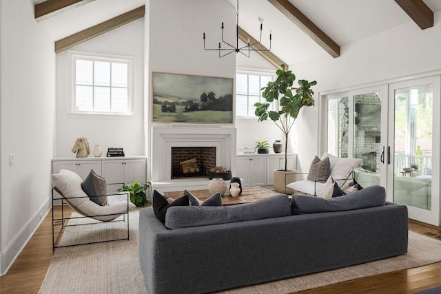 living room featuring a chandelier, hardwood / wood-style floors, and lofted ceiling with beams