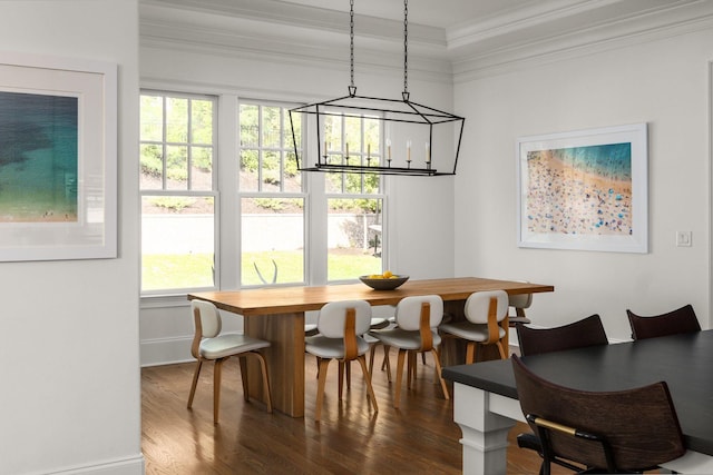 dining room with dark wood-type flooring and ornamental molding