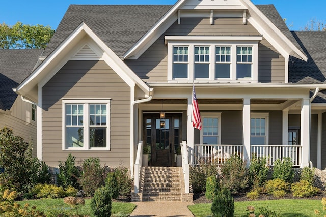 craftsman inspired home with covered porch and french doors