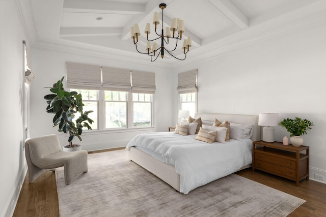 bedroom with beam ceiling, an inviting chandelier, and hardwood / wood-style floors