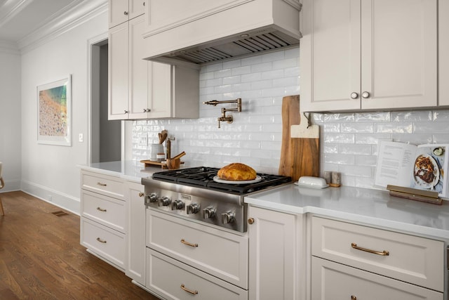 kitchen with white cabinets, backsplash, stainless steel gas cooktop, and custom exhaust hood