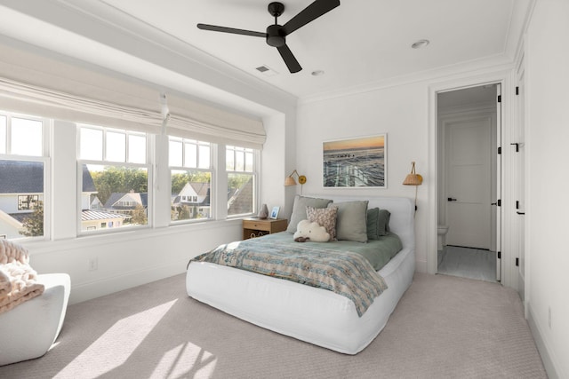 carpeted bedroom with connected bathroom, ceiling fan, and ornamental molding