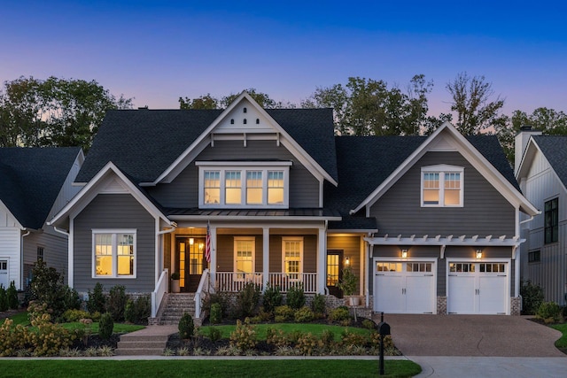 craftsman inspired home with a garage and a porch