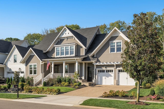 craftsman-style house featuring covered porch and a garage