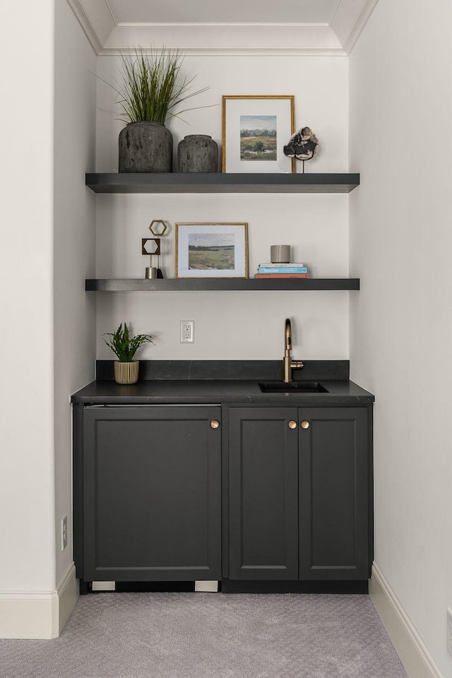 bar with light carpet, sink, and ornamental molding