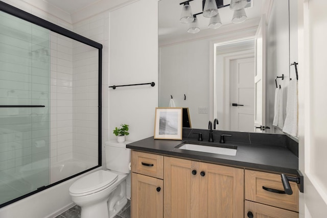 full bathroom with vanity, combined bath / shower with glass door, and toilet