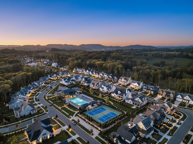 aerial view at dusk featuring a mountain view