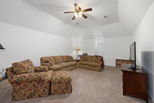 living room with ceiling fan, lofted ceiling, and light carpet