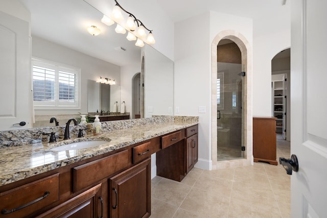 bathroom with vanity, a shower with shower door, and tile patterned floors