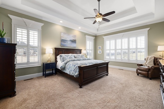 bedroom with light carpet, crown molding, and a raised ceiling