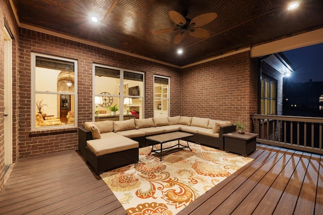 wooden deck with an outdoor living space and ceiling fan