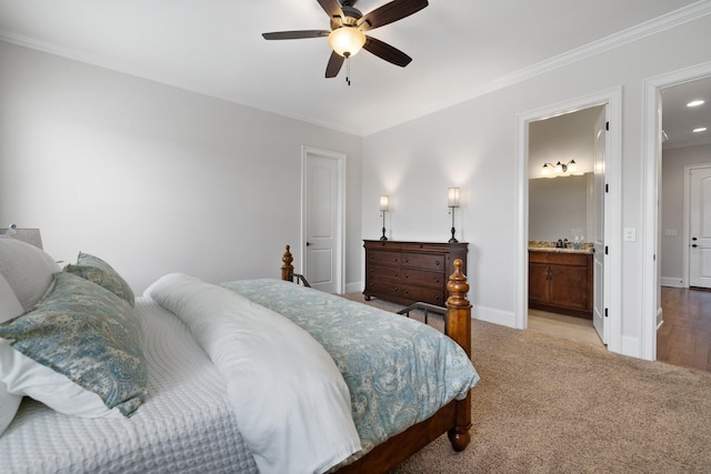 carpeted bedroom featuring ceiling fan, ornamental molding, and ensuite bathroom