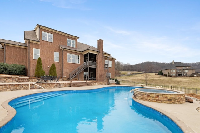 view of pool with an in ground hot tub and a patio