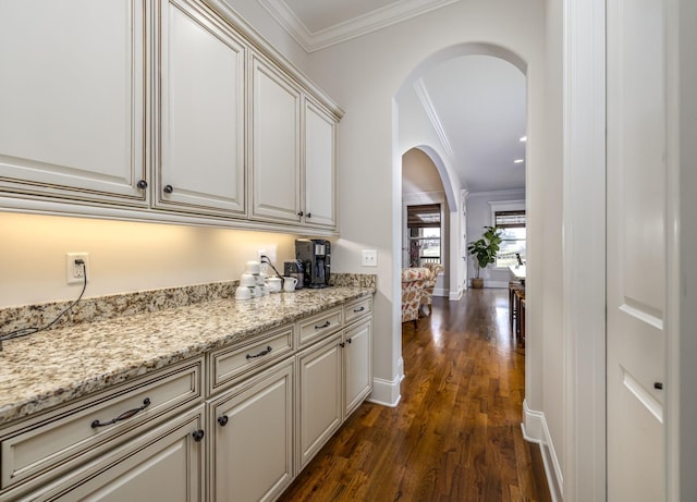 bar with crown molding, dark hardwood / wood-style flooring, and light stone countertops