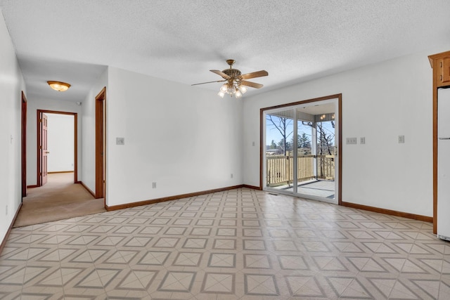 unfurnished room featuring ceiling fan and a textured ceiling