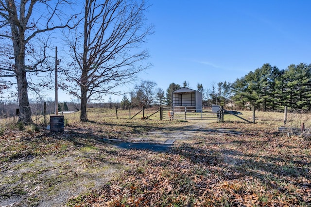 view of yard with a rural view and an outdoor structure