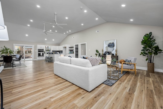 living room with high vaulted ceiling, light hardwood / wood-style flooring, and ceiling fan