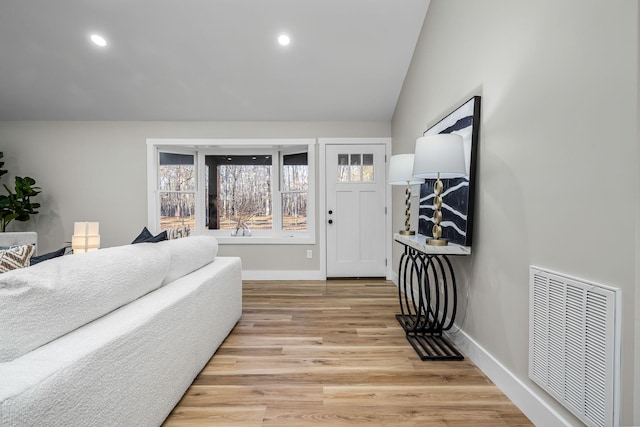 bedroom featuring light wood-type flooring and lofted ceiling