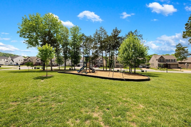 view of property's community featuring a lawn and a playground