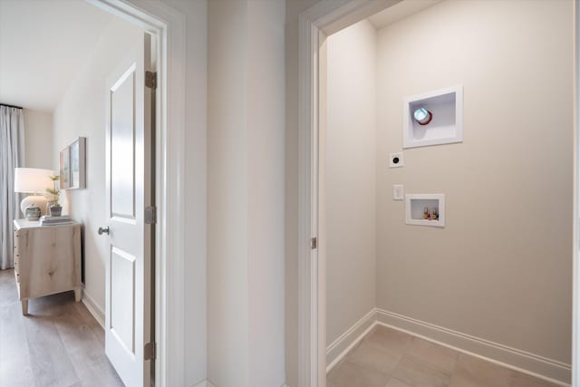 clothes washing area featuring washer hookup, electric dryer hookup, and light hardwood / wood-style flooring