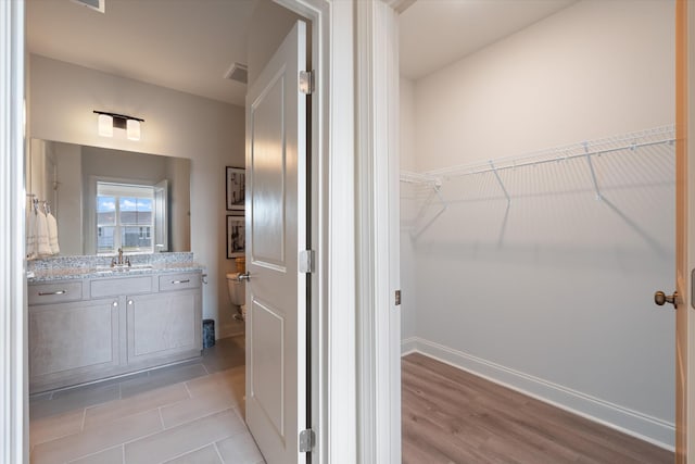 bathroom featuring hardwood / wood-style flooring and vanity