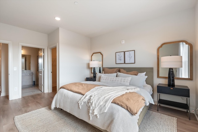 bedroom featuring hardwood / wood-style floors and connected bathroom