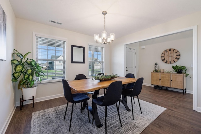 dining area featuring a chandelier and dark hardwood / wood-style flooring