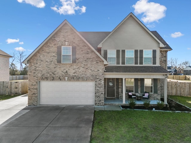 view of front of house with a garage, covered porch, and a front lawn