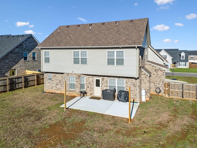 back of property with a lawn and a patio area