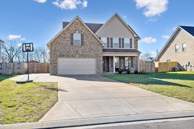 view of property with a front yard, covered porch, central AC unit, and a garage