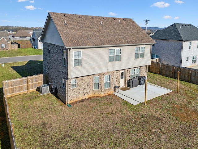 back of property with a yard, a patio, and cooling unit