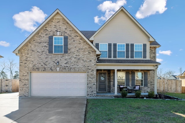 view of front of house with a front yard, a porch, and a garage