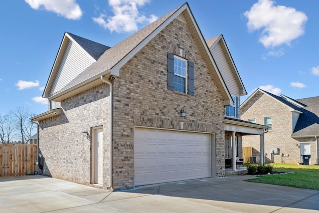 view of front of house featuring a garage and central AC