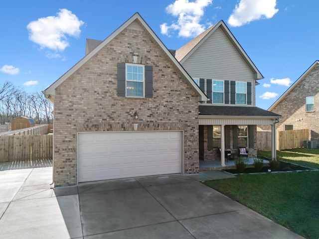 view of front facade featuring a front yard, central AC unit, a porch, and a garage