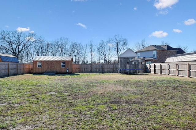 view of yard featuring a storage shed and a trampoline