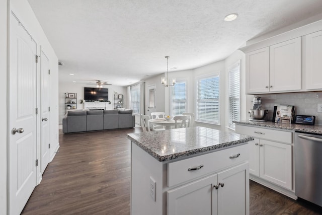 kitchen with dishwasher, backsplash, white cabinetry, and light stone counters