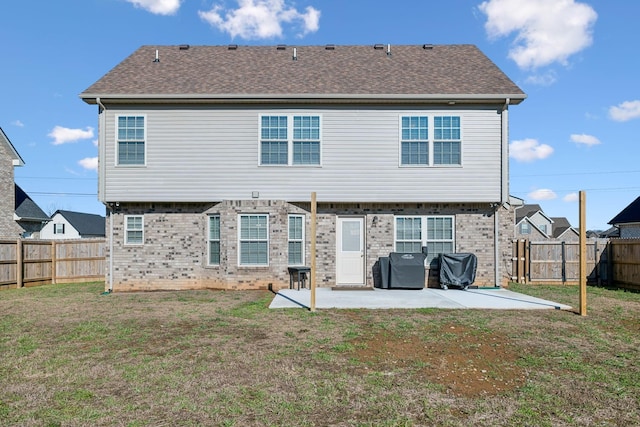 rear view of house featuring a patio area and a lawn