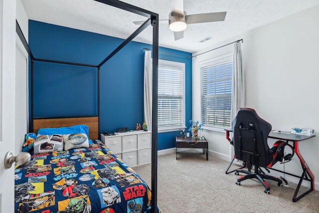 bedroom featuring carpet, ceiling fan, and a textured ceiling