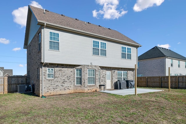 rear view of property with central air condition unit, a patio area, and a yard