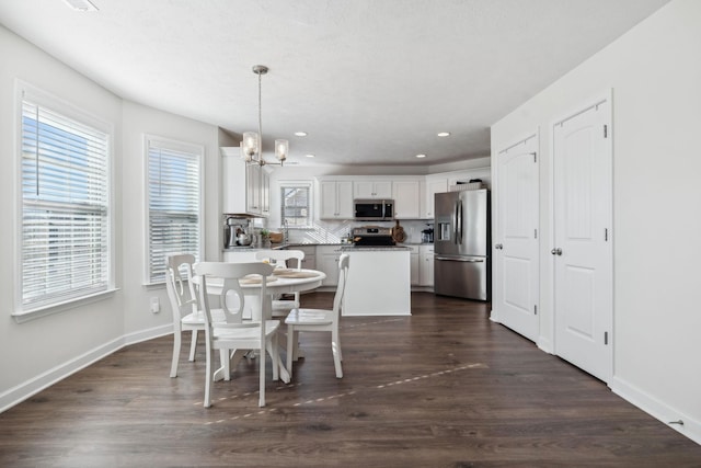 dining area featuring dark hardwood / wood-style floors and a notable chandelier