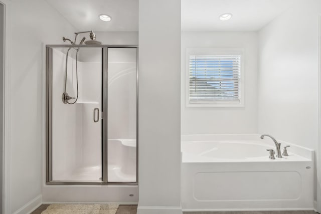 bathroom with separate shower and tub